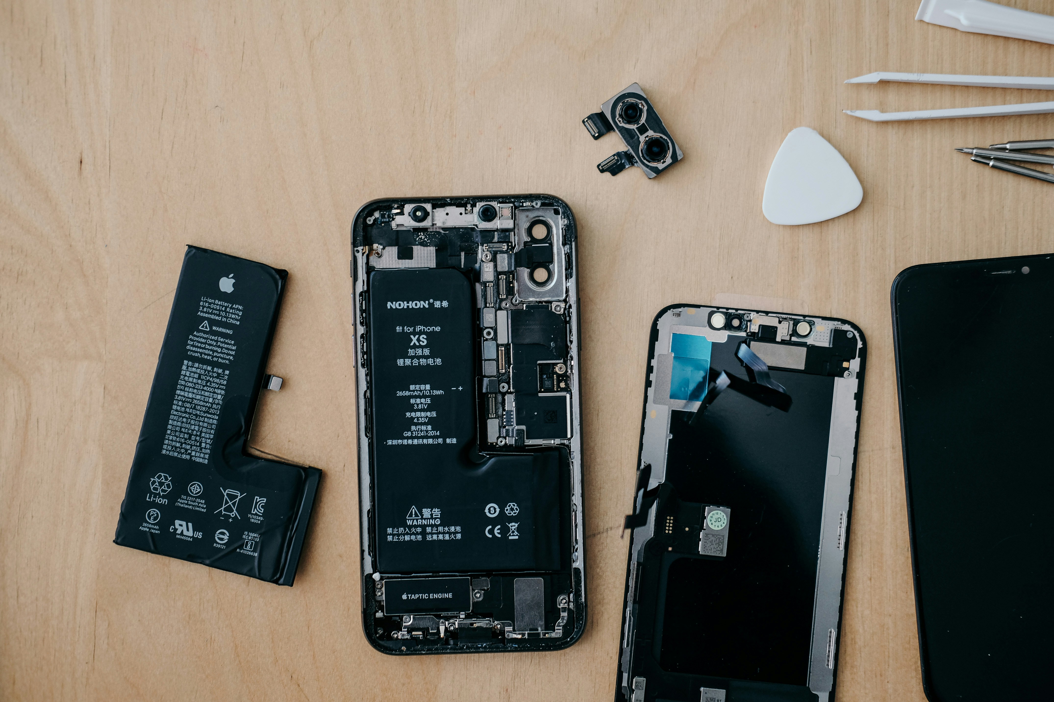 Technician repairing a smartphone on a workbench